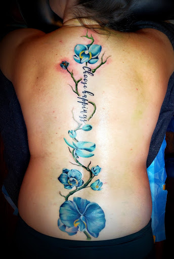 Explore rose thigh tattoo ideas, creative tattoo ideas in Woodward, available at Paper Street Tattoo Company