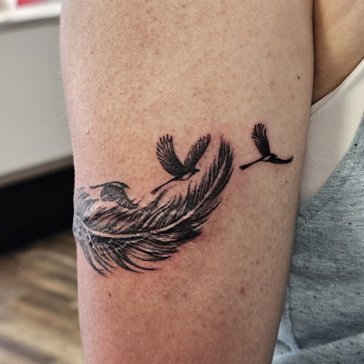Find in between boob tattoo ideas for your next unique tattoo in Traverse City at Pinups & Needles