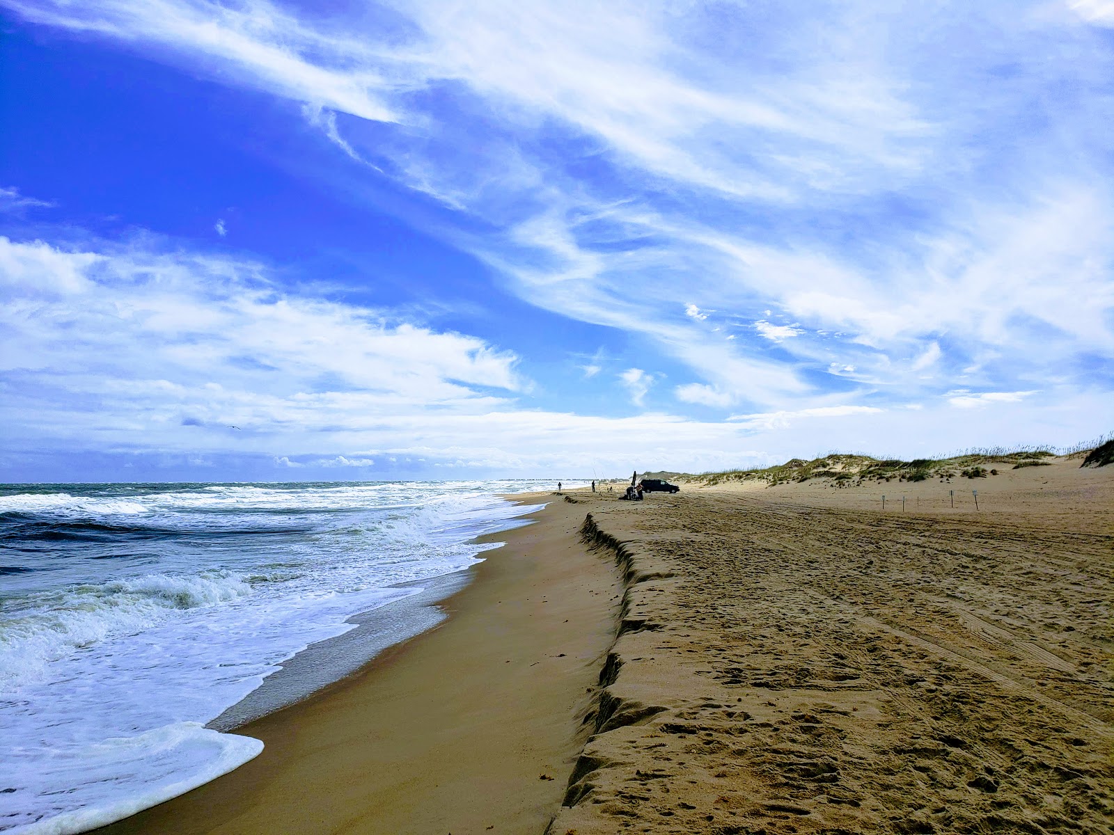 Valokuva Cape Hatteras beachista. pinnalla kirkas hiekka:n kanssa