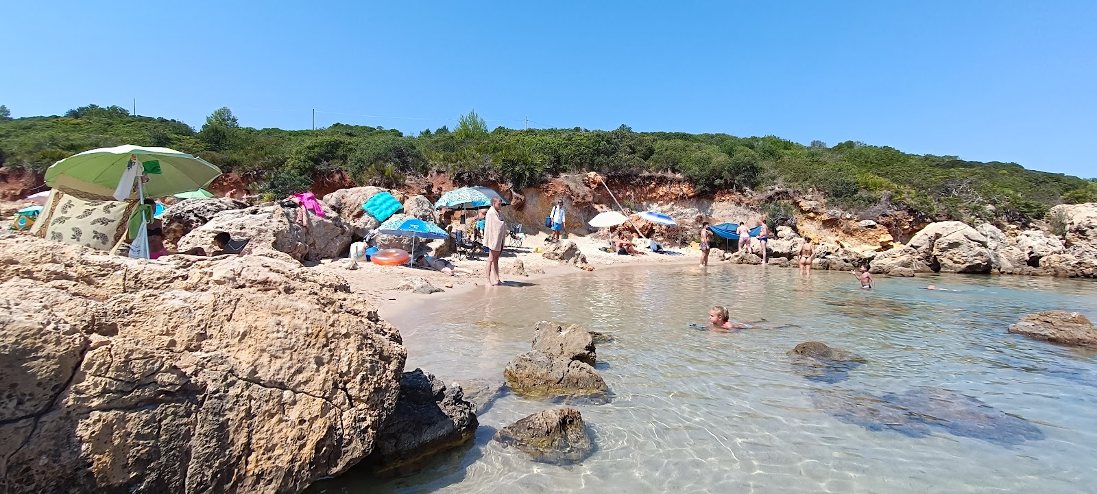 Foto av Cala Spinosa di Alghero med rak strand
