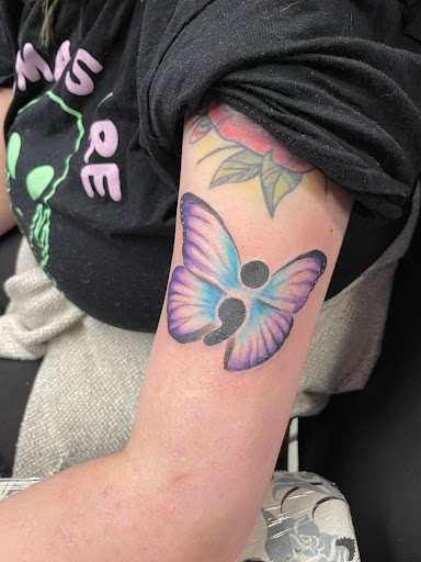 Explore tattoo cover up ideas on leg, creative tattoo ideas in Flint, available at Millennial Ink- Tattoo Shop-Custom Tattoos-Top Tattoo Artist