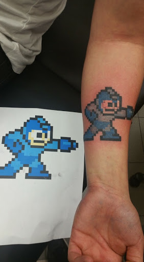 Explore killmonger tattoo ideas, creative tattoo ideas in Hampton, available at Blue Horseshoe Tattoo and Body Piercing