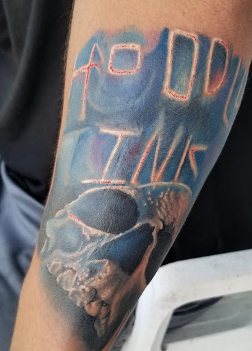 Explore mens tricep tattoo ideas, creative tattoo ideas in Angola, available at Hoodlum Ink