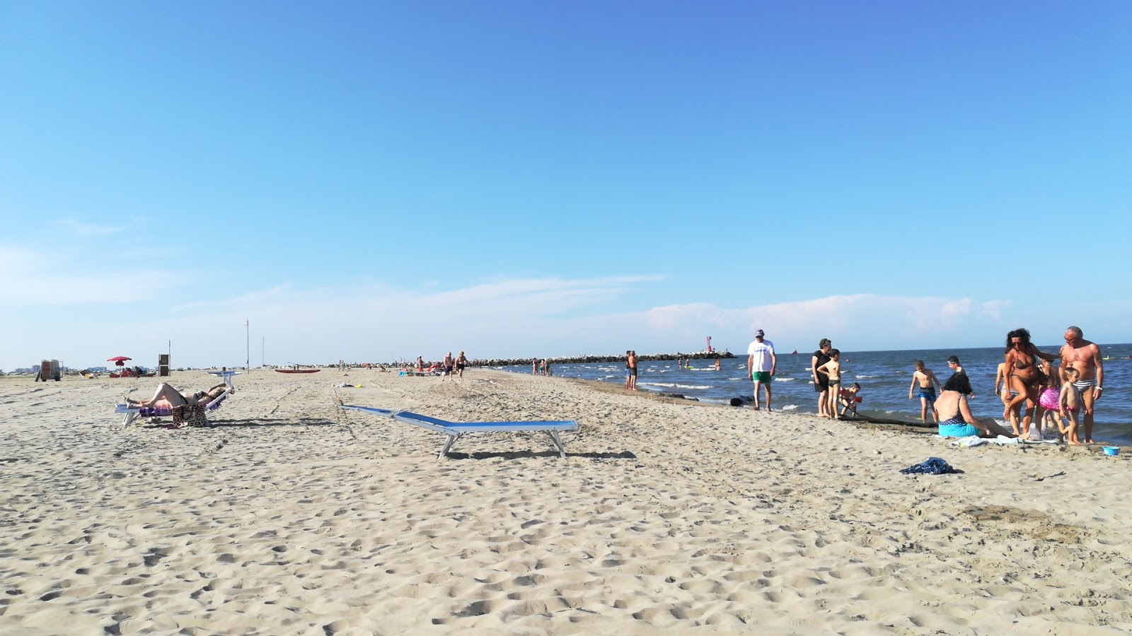 Valokuva Spiaggia Lido Degli Estensiista. pinnalla harmaa hiekka:n kanssa