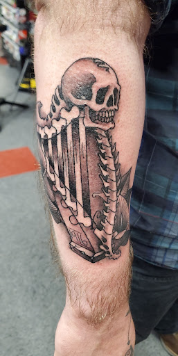 Explore dirtbike tattoo idea, creative tattoo ideas in Saint Paul, available at Black Coffin Tattoo