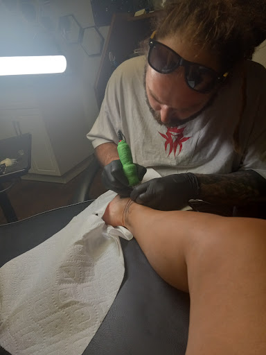 Explore skull hand tattoo ideas, creative tattoo ideas in Lawrenceburg, available at Yellow Rose Tattoo