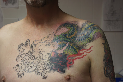 Explore wow tattoo ideas, creative tattoo ideas in Warren, available at Elite Ink Tattoo Studios