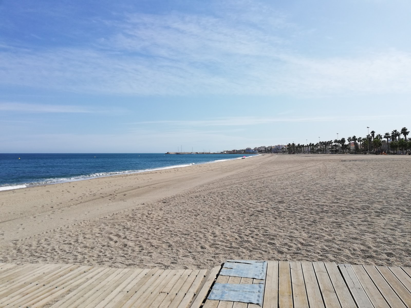 Foto av Playa de la Romanilla med grönt vatten yta