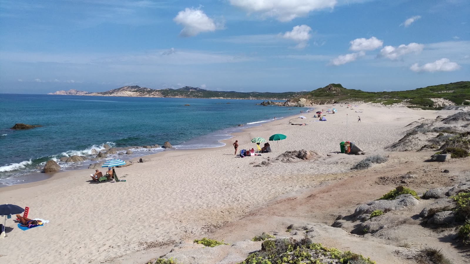 Photo of Cala Pischina with brown sand surface