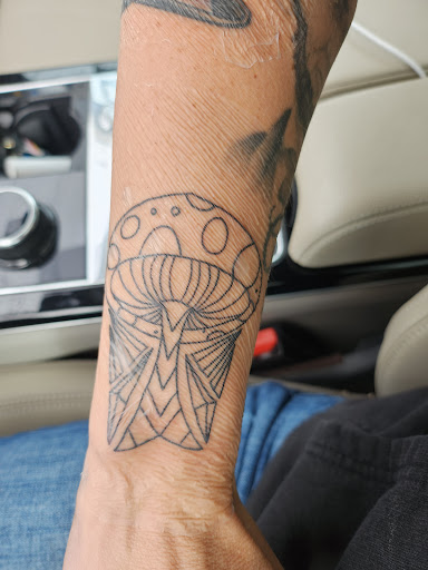 Explore red cardinal tattoo ideas, creative tattoo ideas in Erie, available at Code of Honor Tattoo