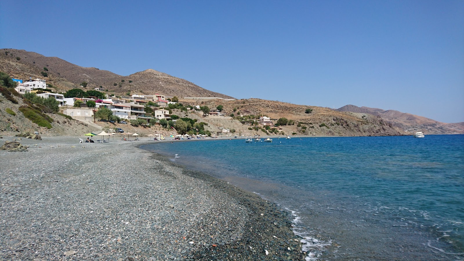 Photo of Chrysostomos beach with gray pebble surface