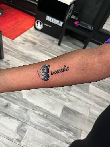 Explore lower back tattoo ideas for men, creative tattoo ideas in Miami, available at INKAHOLIK TATTOOS