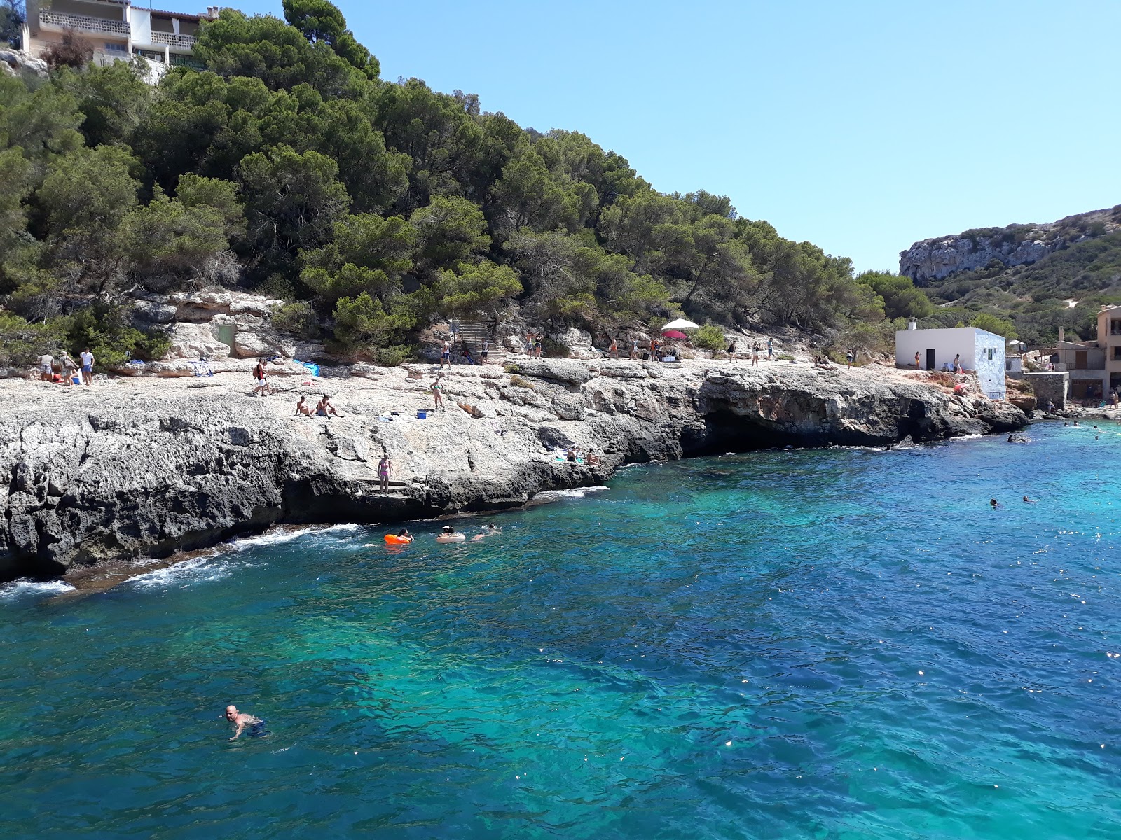 Photo of Cala s'Almunia with turquoise pure water surface