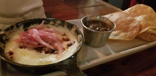 Queso Fundido: melted Oaxaca cheese, chorizo & pickled red onions served with tostaditas.
