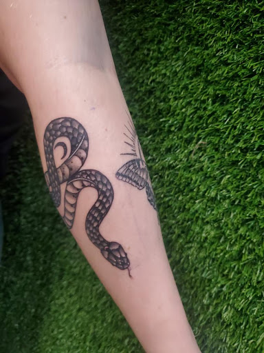 Explore punk rock tattoo ideas, creative tattoo ideas in Cocoa, available at Rorschach Tattoo Shop and Piercing Studio