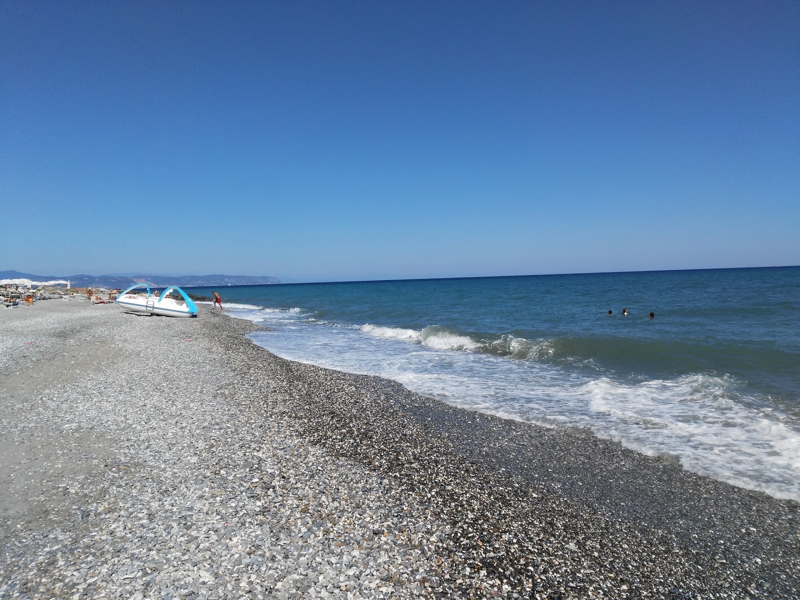 Foto di Doria beach con una superficie del acqua blu