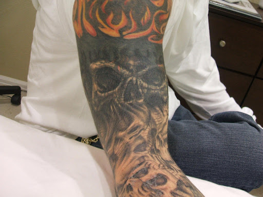 Explore skull forearm tattoo ideas, creative tattoo ideas in Denver, available at INK B GONE Tattoo Removal