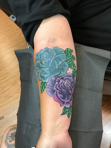 Explore love is pain tattoo ideas, creative tattoo ideas in Orlando, available at Good Vibrations Ink Tattoo and Body Piercing