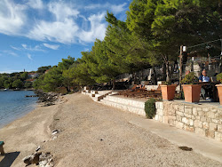 Porto Rosso beach'in fotoğrafı uçurumlarla desteklenmiş
