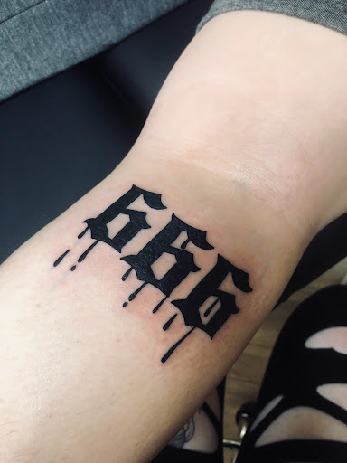 Explore fist tattoo ideas, creative tattoo ideas in North Tonawanda, available at Dark Side Ink Tattoo Studio