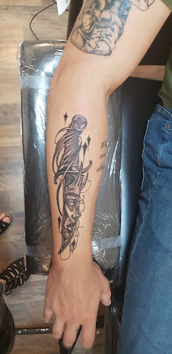 Explore dinosaur tattoo ideas, creative tattoo ideas in Cornelia, available at Prismatic Pulse Tattoo