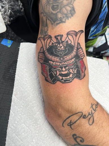 Explore last name back tattoo ideas, creative tattoo ideas in Fort Myers, available at Loyal 2 The Coil Tattoos & Piercings (Edison Mall Location Entrance F)