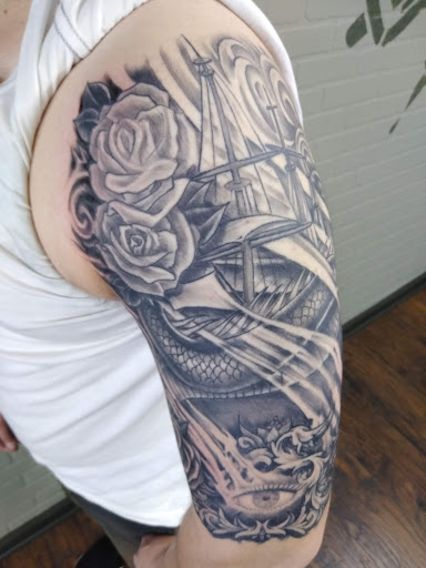 Explore cross tattoo sleeve ideas, creative tattoo ideas in Warren, available at Aces Tattoo & Body Piercing