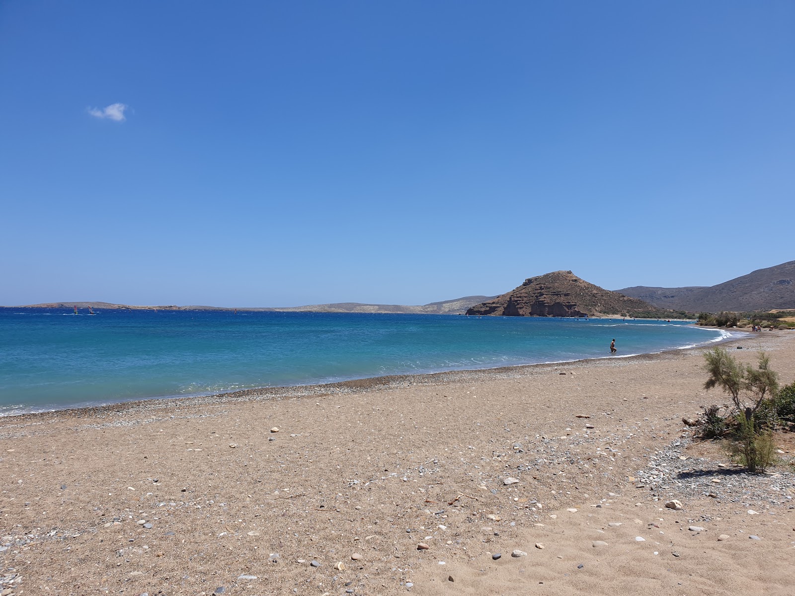 Foto av Kouremenos beach med beige sand och småsten yta