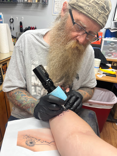 Explore grease tattoo ideas, creative tattoo ideas in Guilford, available at Gizmos Tattoos