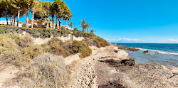 Photo de La Caleta Beach entouré de montagnes