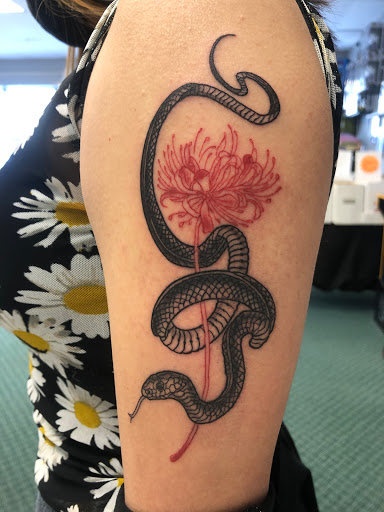 Explore hand and finger tattoo ideas, creative tattoo ideas in Alamosa, available at The Shop Tattoo & Comics