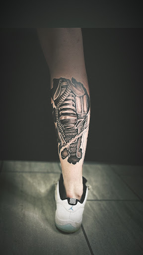 Explore banksy tattoo ideas, creative tattoo ideas in Cadillac, available at Limitless Ink Tattoo Studio