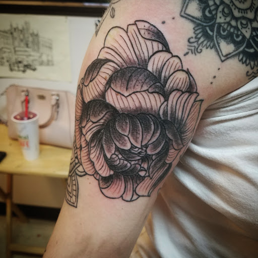 Explore tattoo ideas for brother, creative tattoo ideas in Flint, available at Black Eye Social Club Tattoo