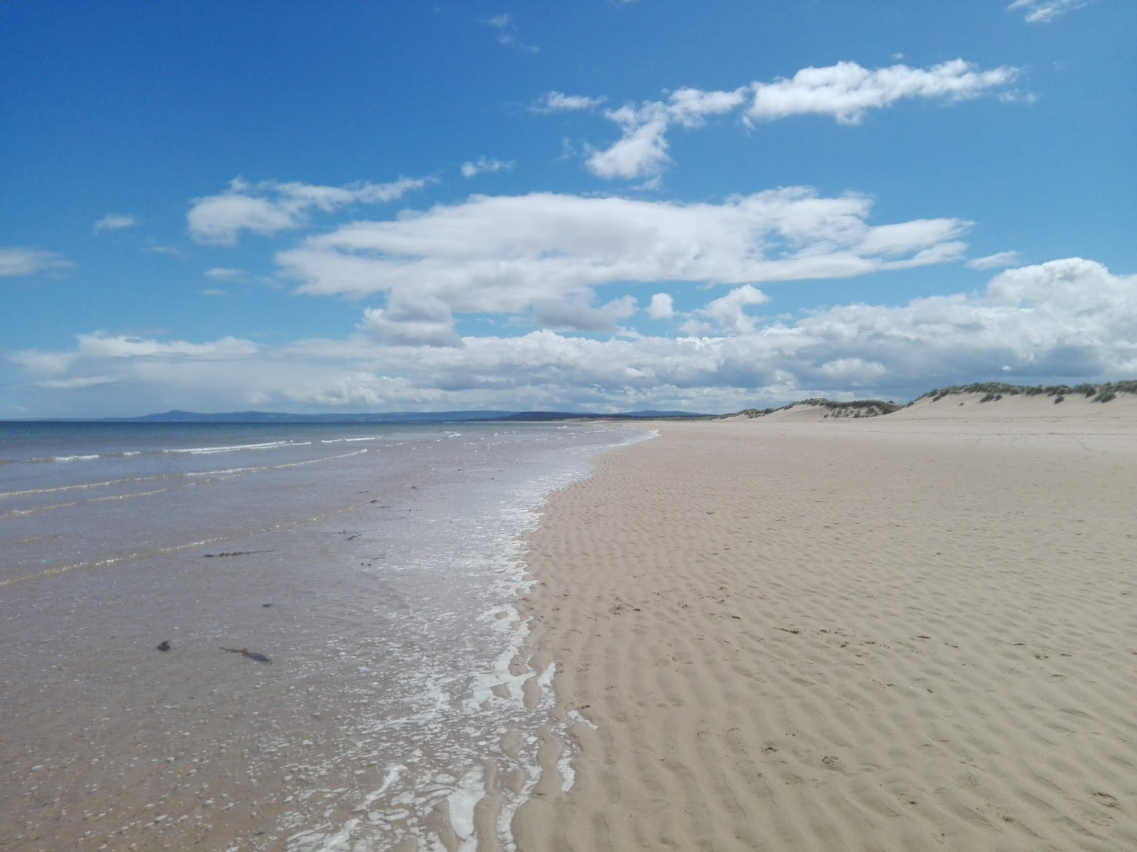 Photo of Lossiemouth East Beach with turquoise pure water surface