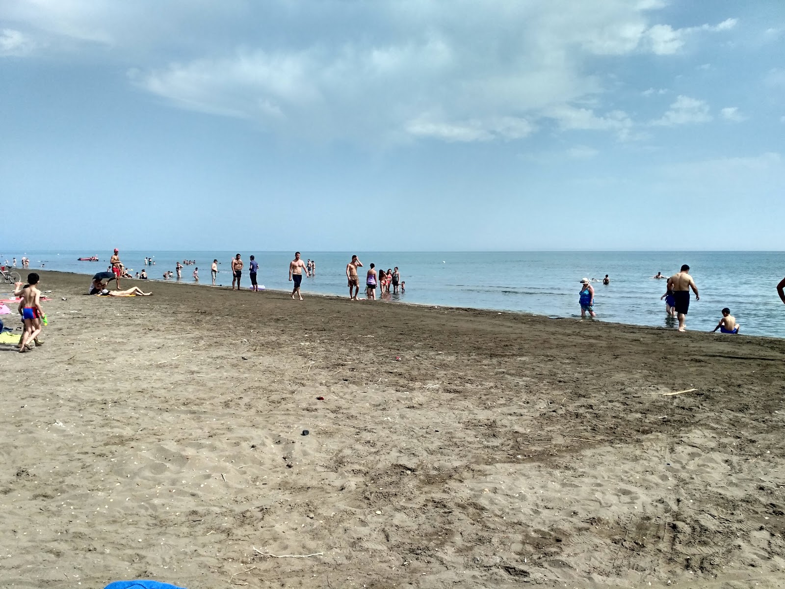 Valokuva Plazh Muhtadirista. pinnalla harmaa hiekka:n kanssa