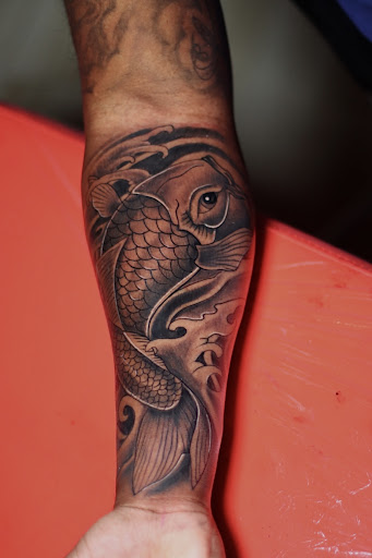 Explore fist bump tattoo ideas, creative tattoo ideas in Starkville, available at Xclusive Ink Tattoo Company