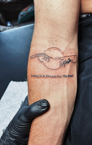Explore wrap around wrist tattoo ideas, creative tattoo ideas in Burley, available at Fine Line Ink