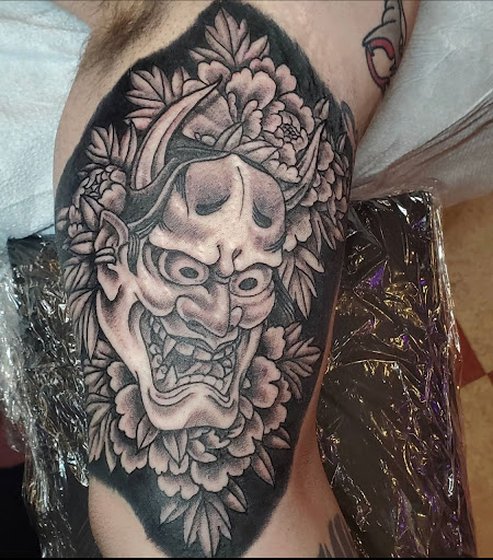 Explore joker card tattoo ideas, creative tattoo ideas in Mchenry, available at Lunchbox Tattoo and Body Piercing