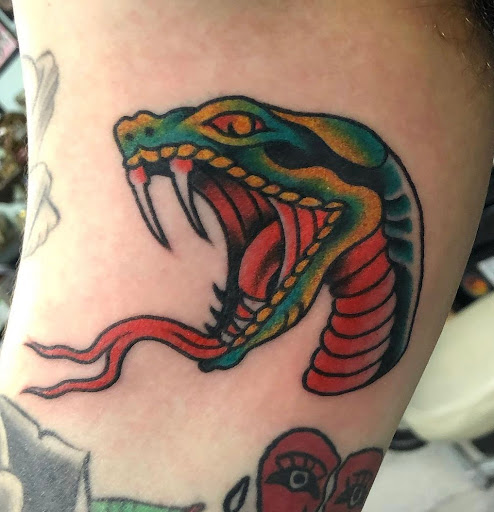 Explore men's shin tattoo ideas, creative tattoo ideas in Orange, available at Black Palm Tattoo