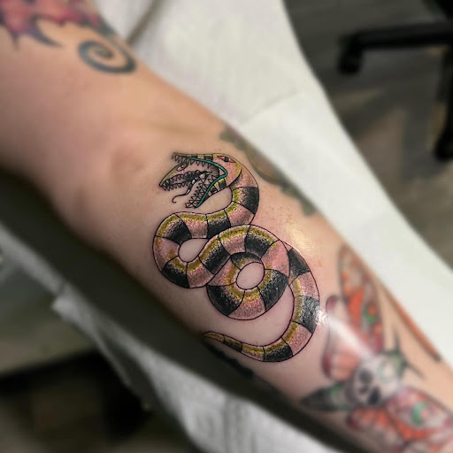 Explore wrap around tattoo ideas, creative tattoo ideas in Greenfield, available at Garden of Eden Tattoos