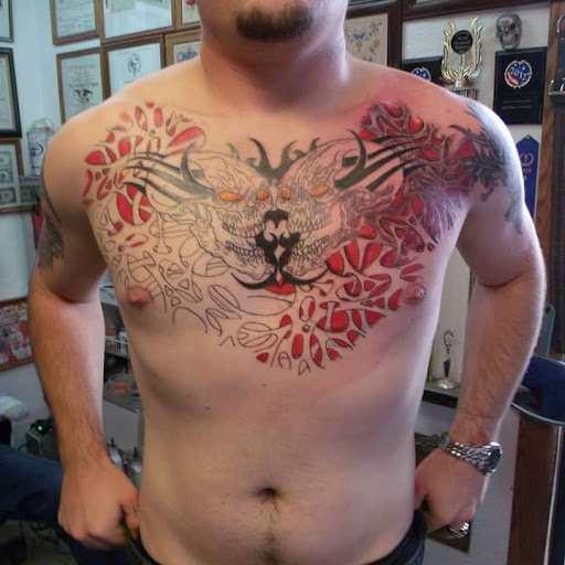 Explore rip cross tattoo ideas, creative tattoo ideas in Elko, available at Tom Custom Tattoos and Body Piercing Studio