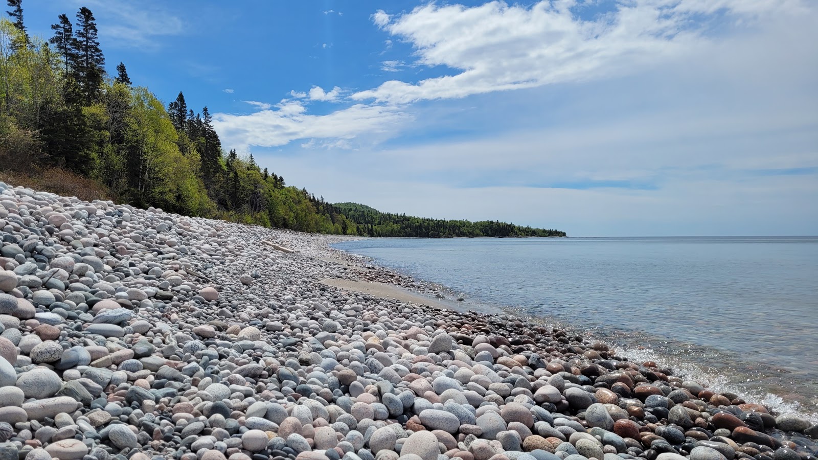 Photo of Pebble beach with long straight shore