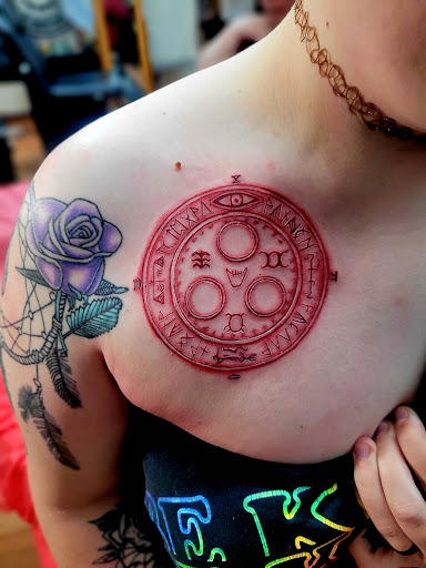 Explore maltese cross tattoo ideas, creative tattoo ideas in Benton, available at Spectrum Tattoo