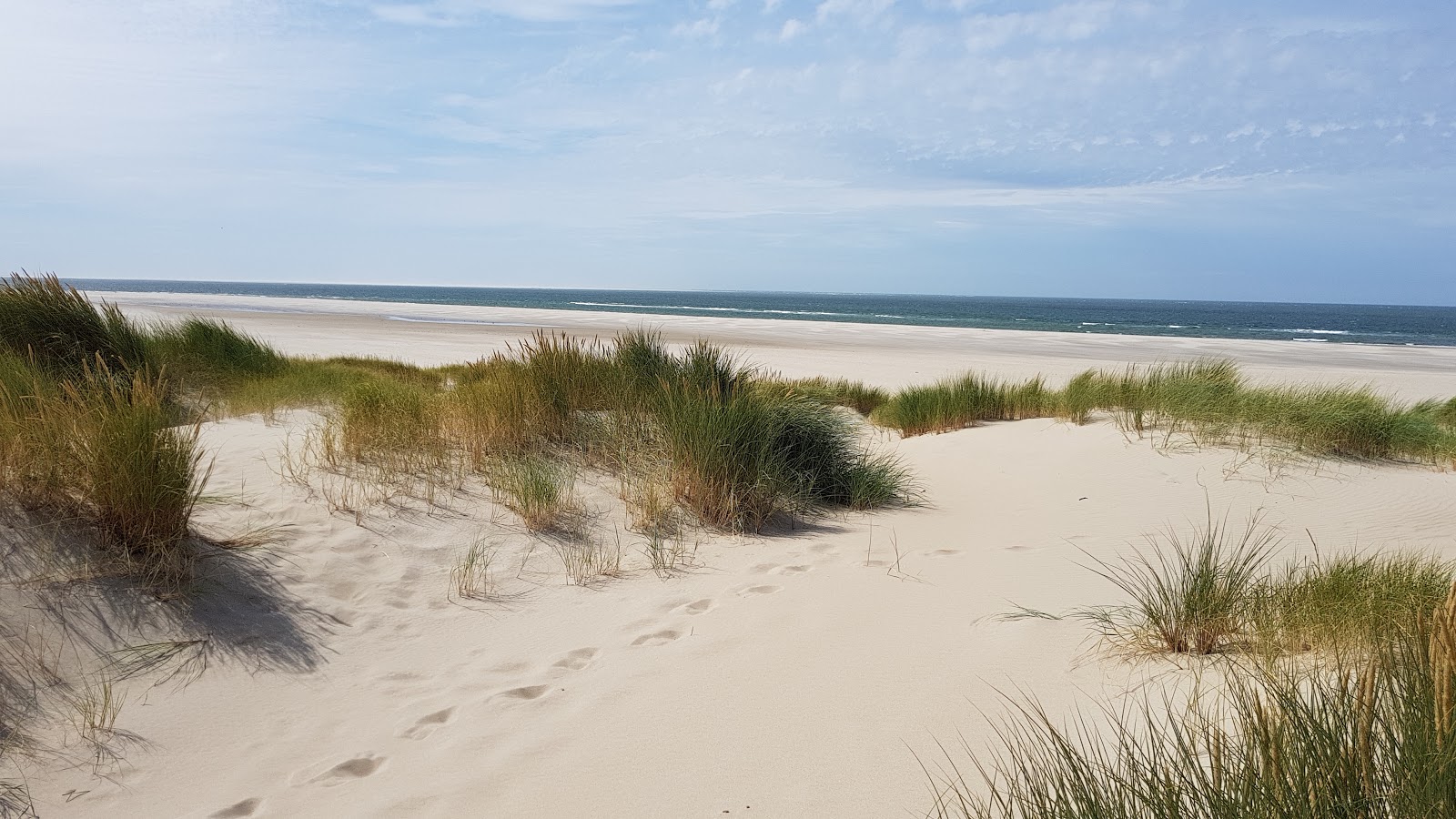 Fotografija De Hors z beli pesek površino