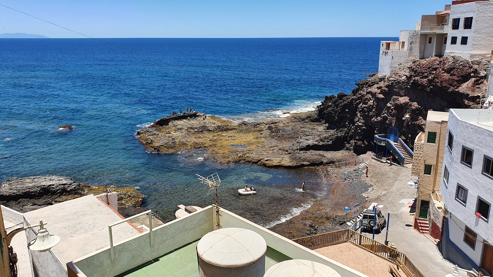 Foto von Playa de Caleta de Arriba mit brauner sand & felsen Oberfläche