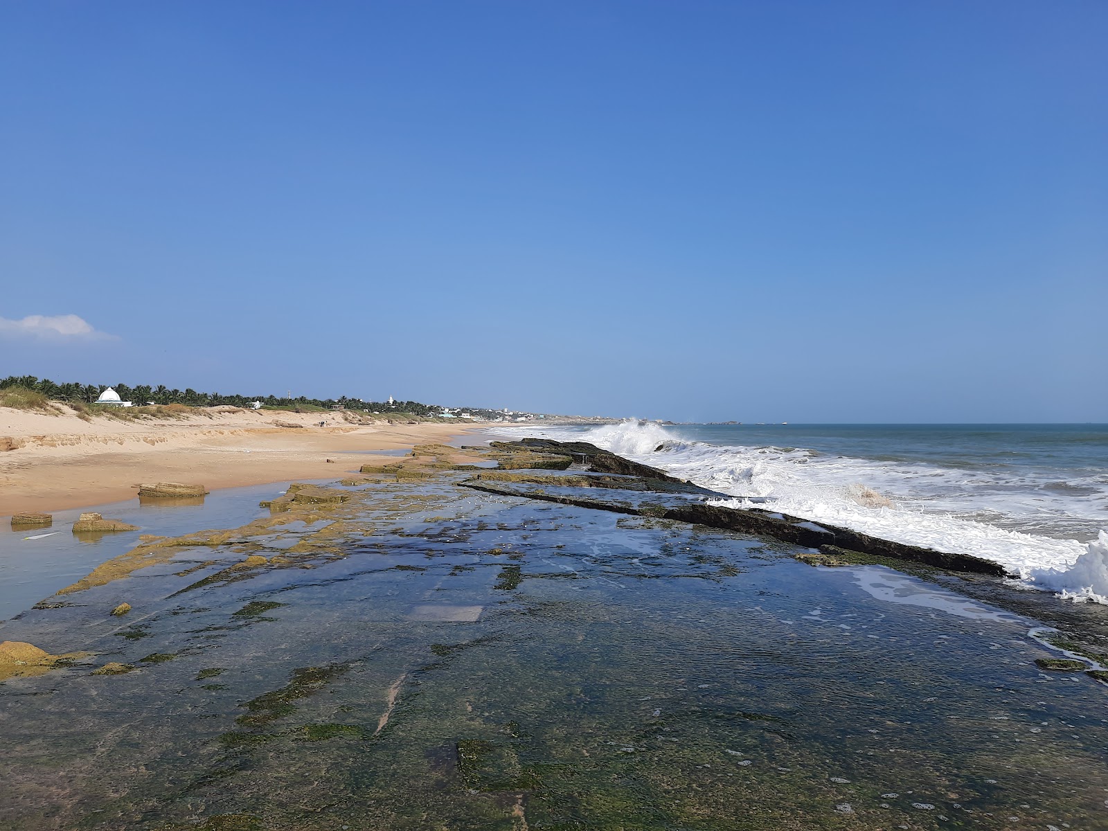 Valokuva Dwarakapathi Beachista. pinnalla turkoosi puhdas vesi:n kanssa