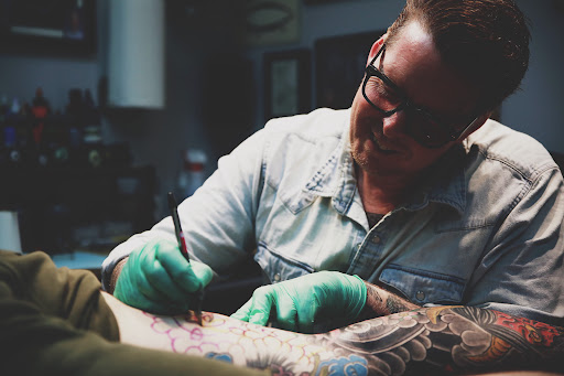 Explore cross cover up tattoo ideas, creative tattoo ideas in Neptune, available at Neptune Tattooville