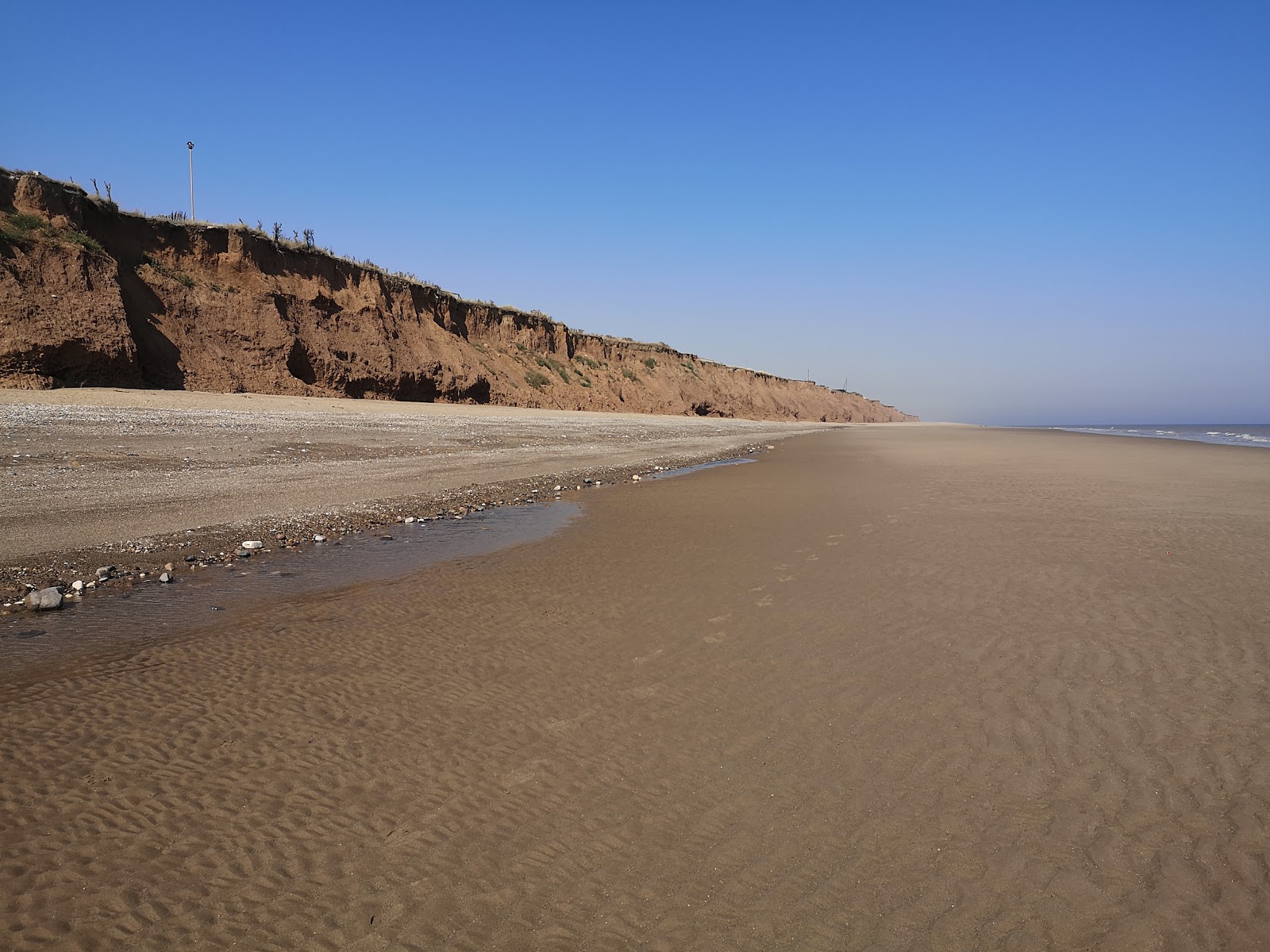 Foto van Tunstall strand met bruin zand oppervlakte