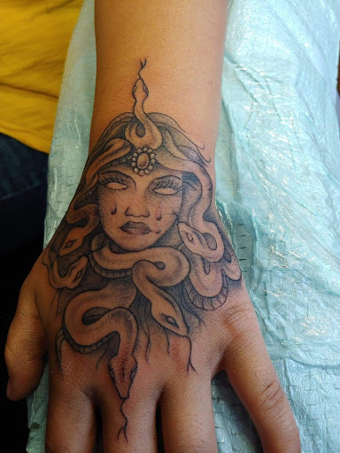 Explore fear god tattoo ideas, creative tattoo ideas in Williamston, available at Inkd Tattoo Parlor