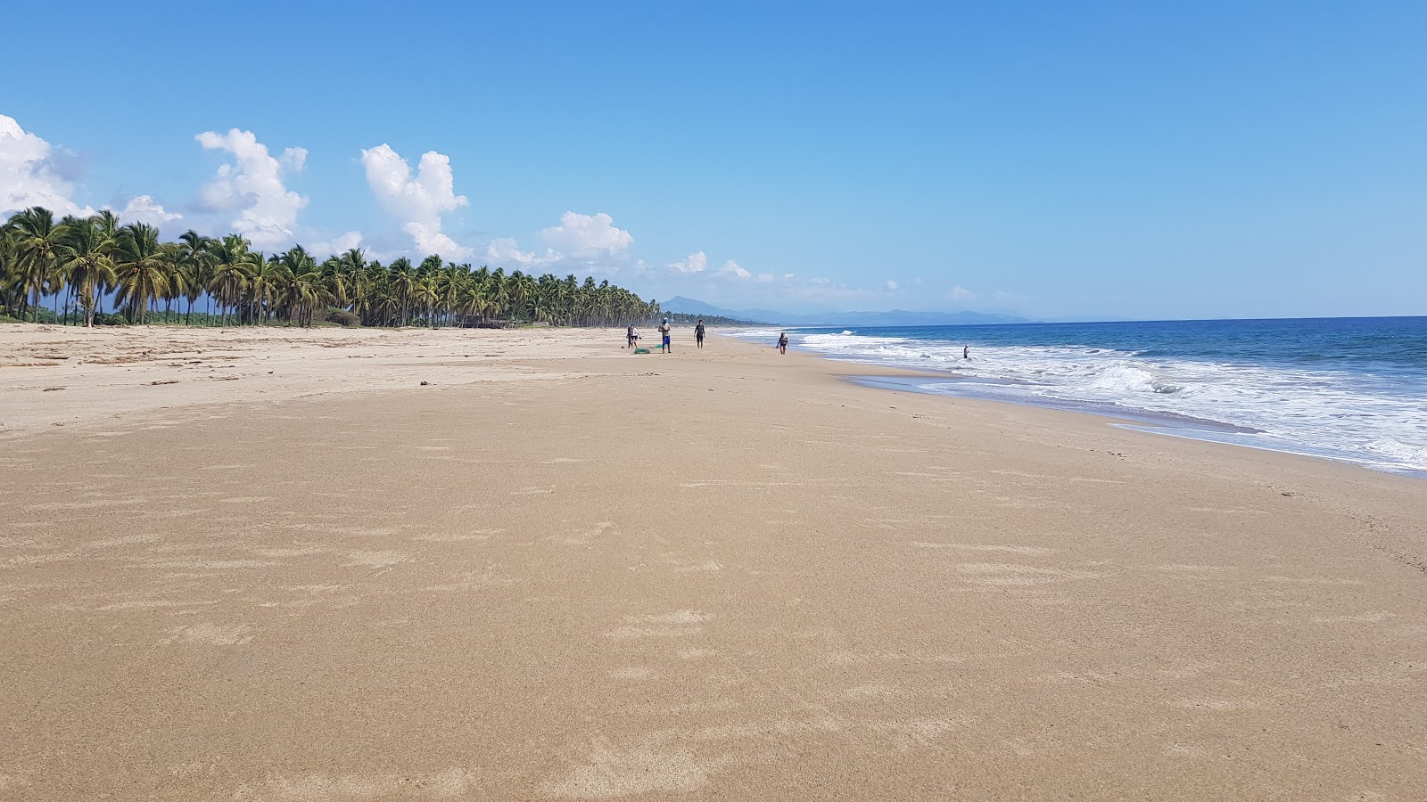 Foto di Playa Valentin con una superficie del sabbia beige